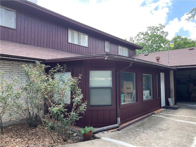 5218 Wooldridge Rd, Corpus Christi, TX 78413 - view of exterior entry with a shingled roof and brick siding