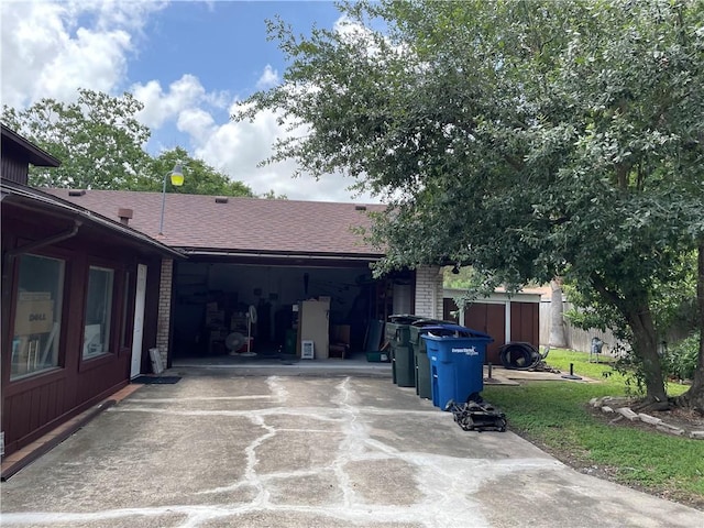 5218 Wooldridge Rd, Corpus Christi, TX 78413 - view of side of home with concrete driveway, roof with shingles, and brick siding