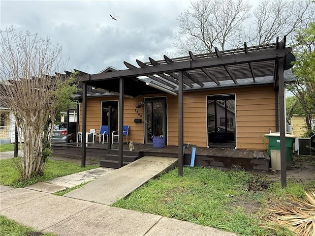 view of front of home with central air condition unit and a pergola