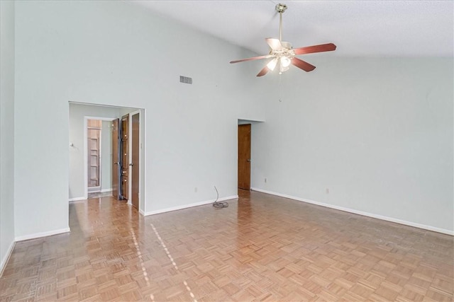 spare room with ceiling fan, light parquet flooring, and high vaulted ceiling