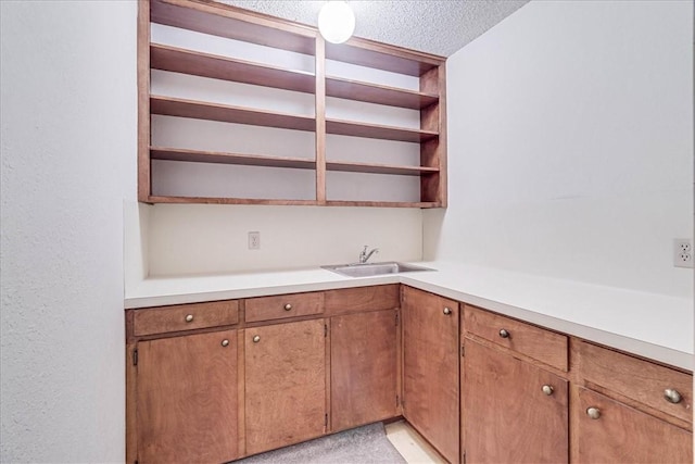 kitchen featuring sink and a textured ceiling