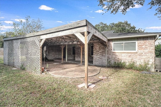 rear view of property with a patio area and a lawn