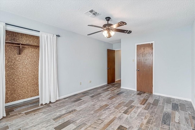 unfurnished bedroom featuring a textured ceiling and light wood-type flooring