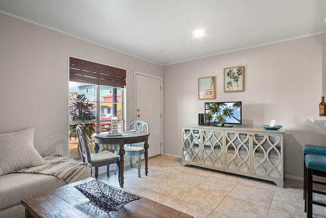 living room featuring ornamental molding and light tile patterned flooring