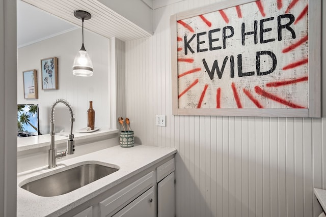 interior space with wood walls, crown molding, and vanity