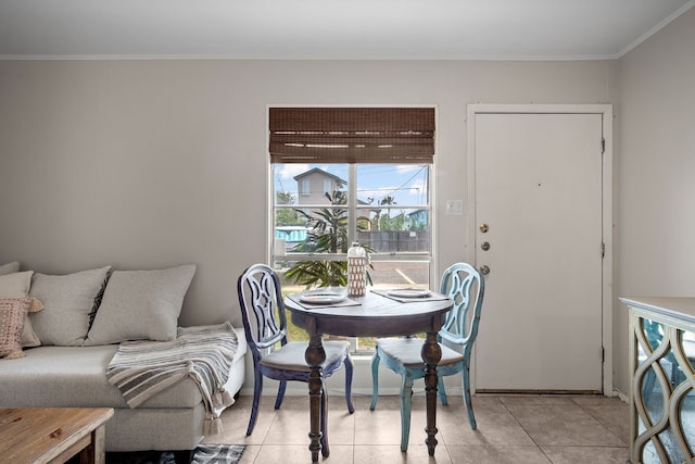 tiled dining room featuring crown molding