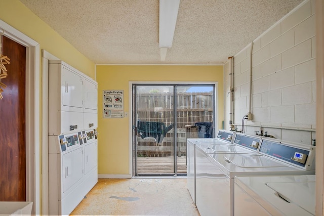 clothes washing area with stacked washing maching and dryer, a textured ceiling, and washer and clothes dryer