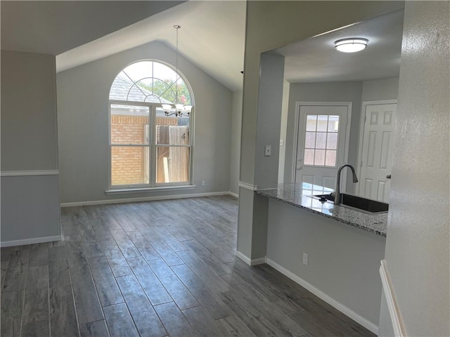 unfurnished dining area featuring sink and vaulted ceiling