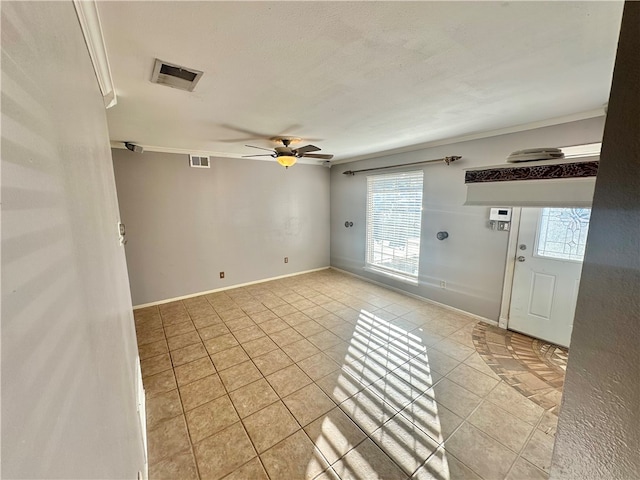 unfurnished room with ceiling fan, a textured ceiling, and light tile patterned floors