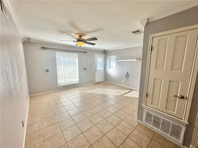 tiled spare room featuring ceiling fan and crown molding