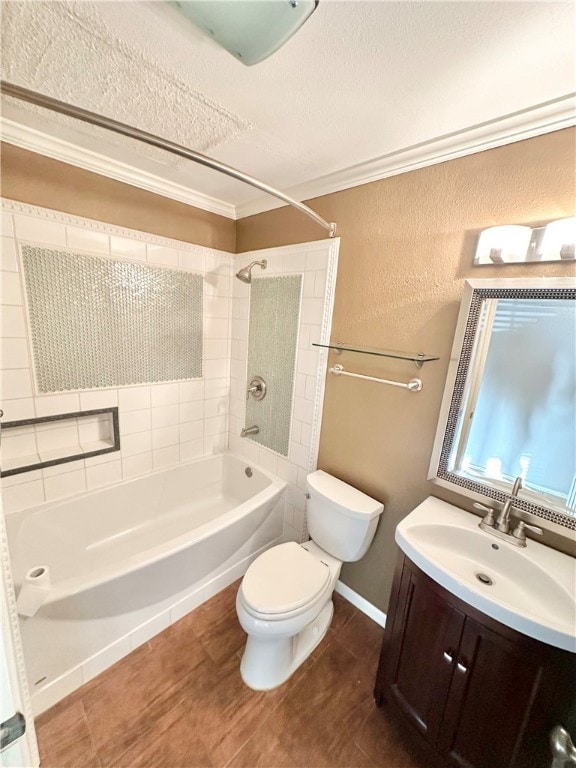 full bathroom with crown molding, vanity, a textured ceiling, tiled shower / bath combo, and toilet