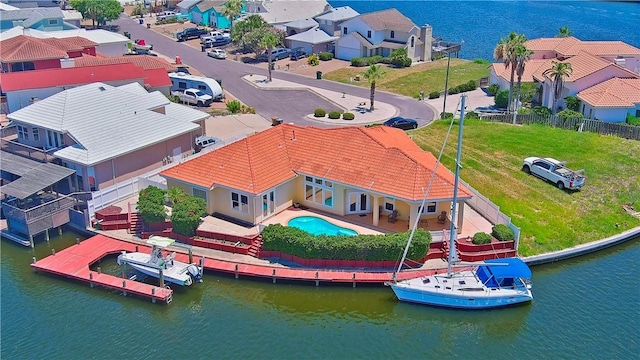 drone / aerial view with a water view and a residential view