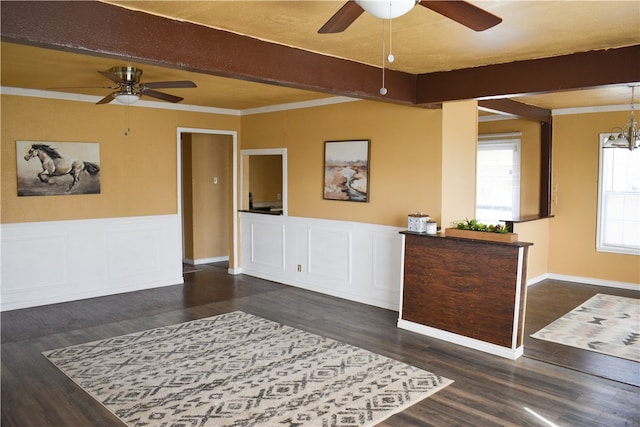 interior space with dark wood-type flooring, ceiling fan with notable chandelier, beamed ceiling, and ornamental molding