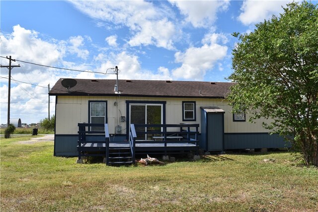 back of house with a wooden deck and a yard