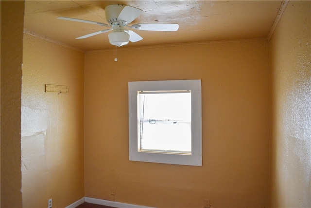 unfurnished room with ornamental molding and ceiling fan