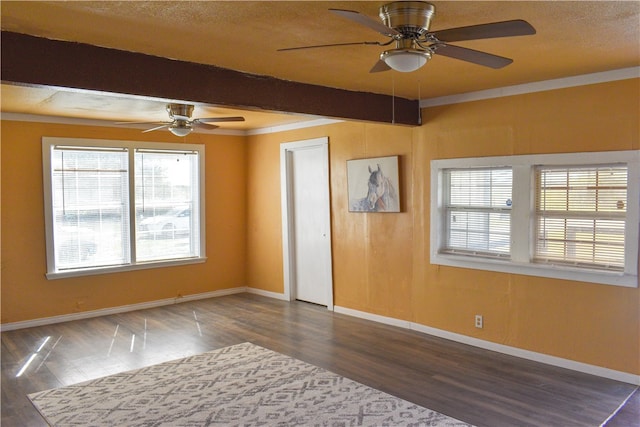 unfurnished room with ornamental molding, beamed ceiling, and dark hardwood / wood-style floors