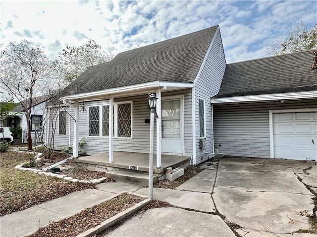 view of front of property featuring a porch and a garage