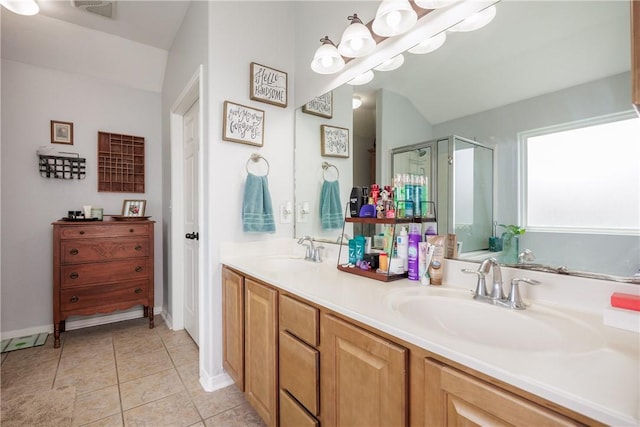 6005 Tapestry Dr, Corpus Christi, TX 78414 - bathroom with a stall shower, double vanity, baseboards, lofted ceiling, and tile patterned flooring