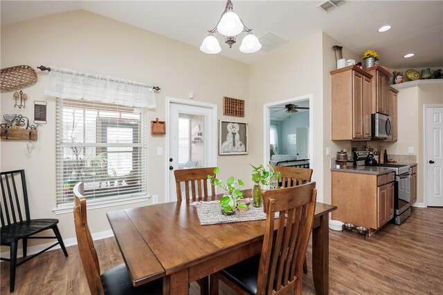 6005 Tapestry Dr, Corpus Christi, TX 78414 - dining area with dark wood finished floors, a chandelier, a ceiling fan, vaulted ceiling, and recessed lighting