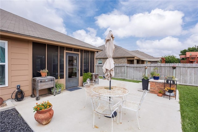 6005 Tapestry Dr, Corpus Christi, TX 78414 - view of patio with a sunroom, a fenced backyard, and outdoor dining area