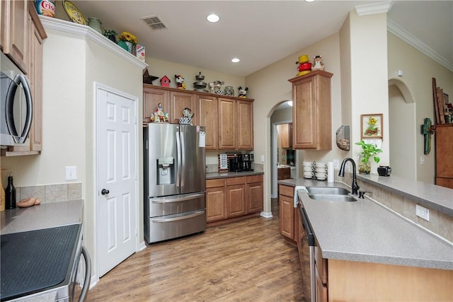 6005 Tapestry Dr, Corpus Christi, TX 78414 - kitchen with appliances with stainless steel finishes, arched walkways, a sink, light wood-type flooring, and recessed lighting