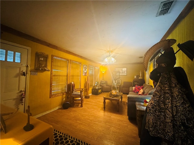 interior space with hardwood / wood-style floors and ornamental molding