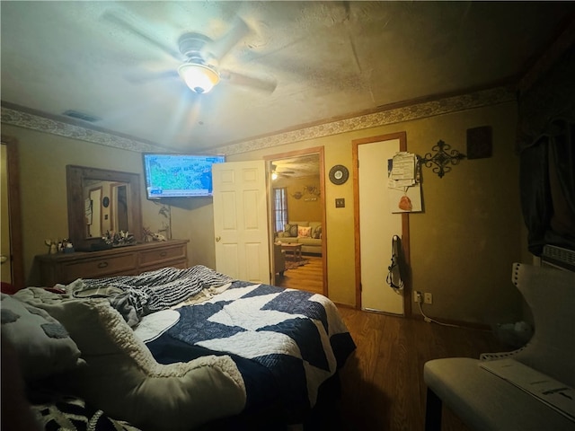 bedroom with ceiling fan and wood-type flooring