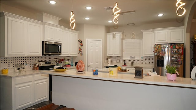 2705 Quebec Dr, Corpus Christi, TX 78414 - kitchen featuring stainless steel appliances, backsplash, white cabinets, and recessed lighting