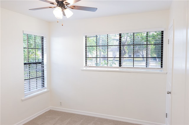 unfurnished room featuring light colored carpet and ceiling fan