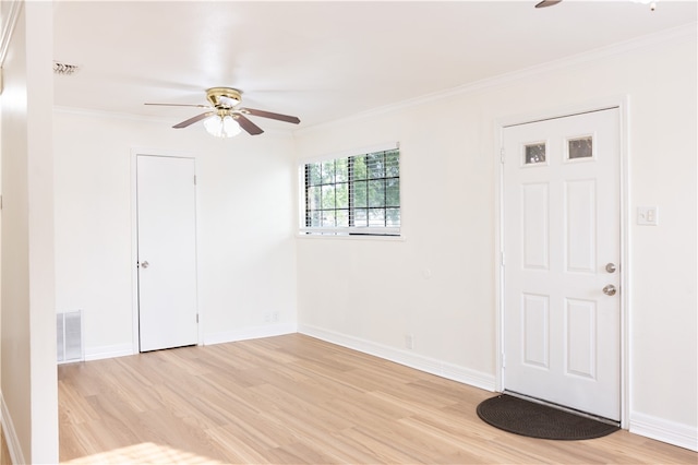 spare room featuring ceiling fan, ornamental molding, and light hardwood / wood-style flooring