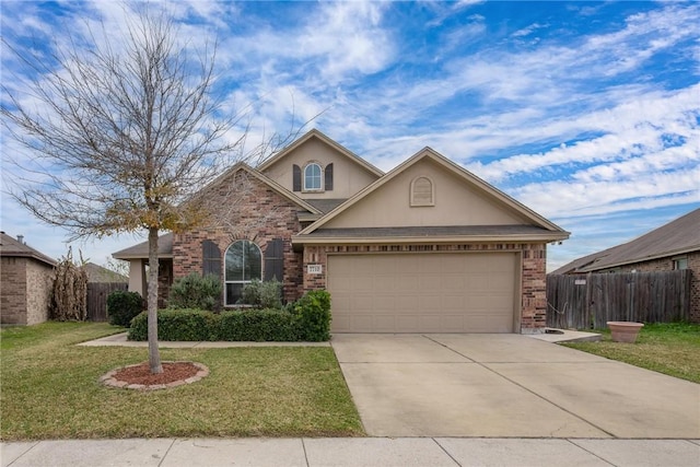 view of front of home featuring driveway, brick siding, fence, a front lawn, and stucco siding