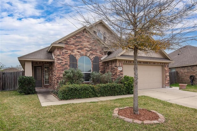 traditional-style home featuring an attached garage, brick siding, fence, driveway, and a front lawn