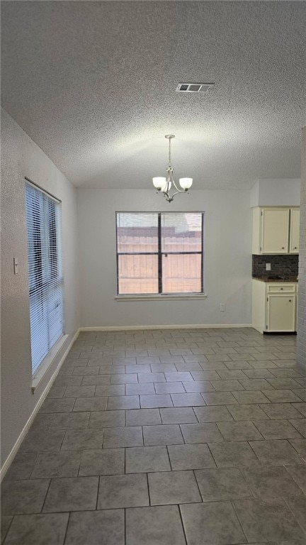 4433 Aspen Grove Dr, Corpus Christi, TX 78413 - empty room with a chandelier and a textured ceiling
