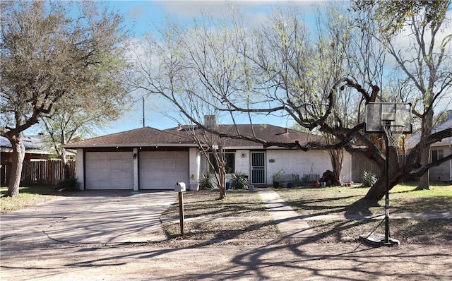 ranch-style house with a garage, brick siding, concrete driveway, and fence