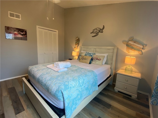 bedroom featuring dark hardwood / wood-style floors and a closet