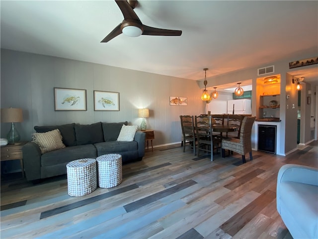 living room featuring hardwood / wood-style flooring and ceiling fan