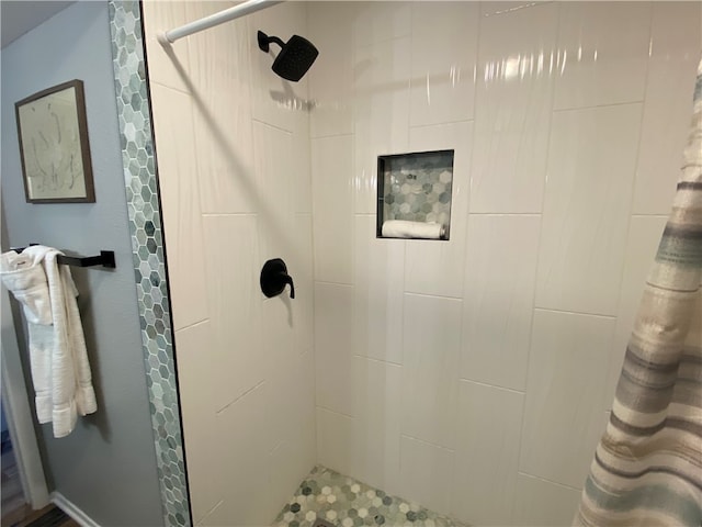 bathroom with a tile shower