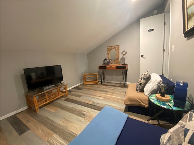 living room featuring hardwood / wood-style floors and vaulted ceiling