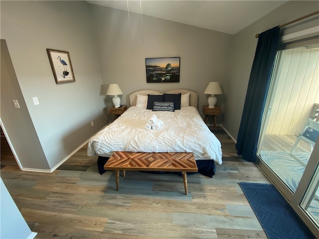 bedroom with vaulted ceiling and wood-type flooring