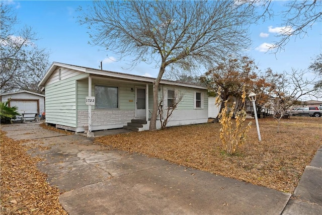 view of front of home featuring a garage and an outdoor structure