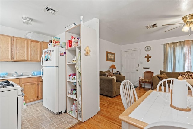 kitchen featuring ceiling fan, light brown cabinets, white appliances, and light hardwood / wood-style floors