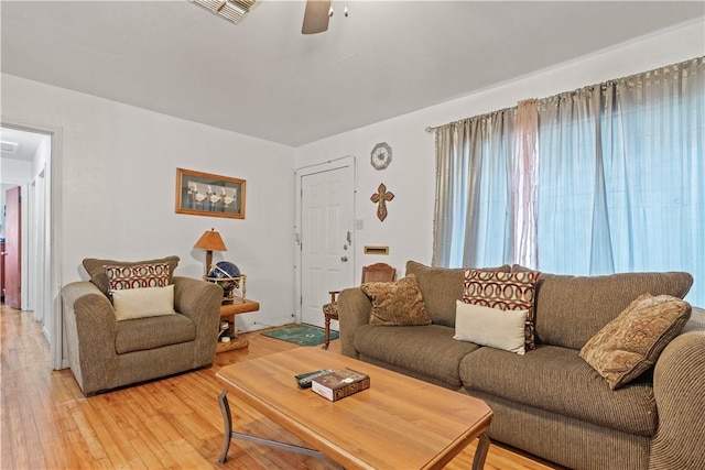 living room with ceiling fan and wood-type flooring