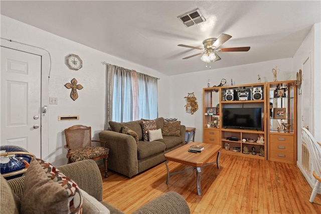 living room with ceiling fan and light wood-type flooring