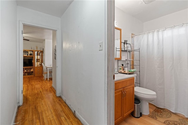 bathroom with vanity, toilet, and wood-type flooring