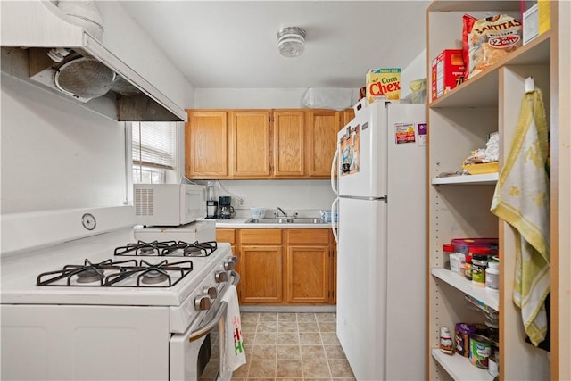 kitchen with white appliances, range hood, and sink