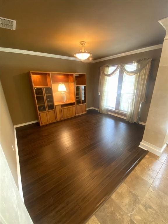 unfurnished living room with crown molding