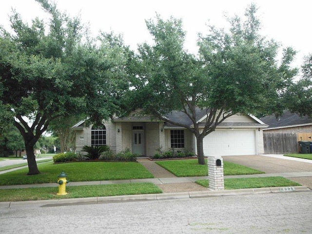 ranch-style house featuring a garage and a front yard