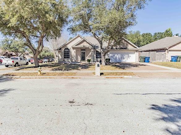 view of front of property featuring concrete driveway and an attached garage