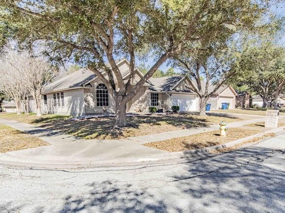 single story home featuring driveway and a garage