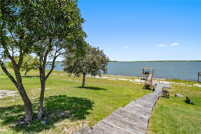 dock area featuring a water view and a yard